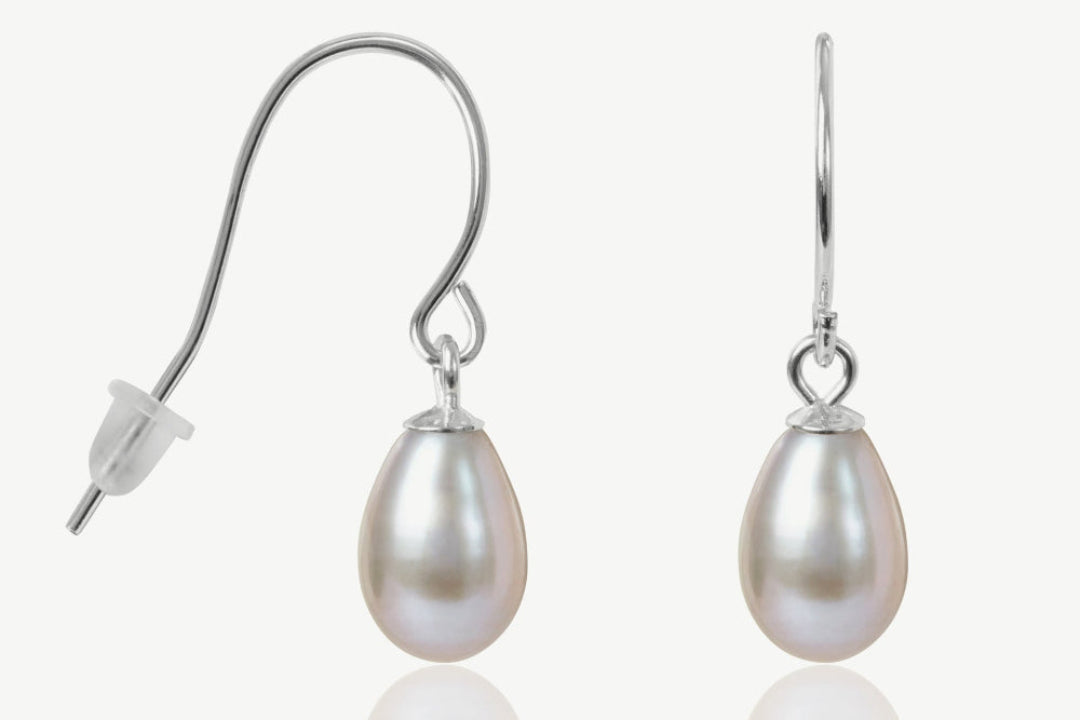 Pearl earrings with silver hooks on a white background