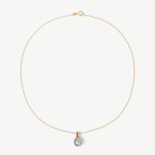 Gold necklace with a single pearl pendant on a white background