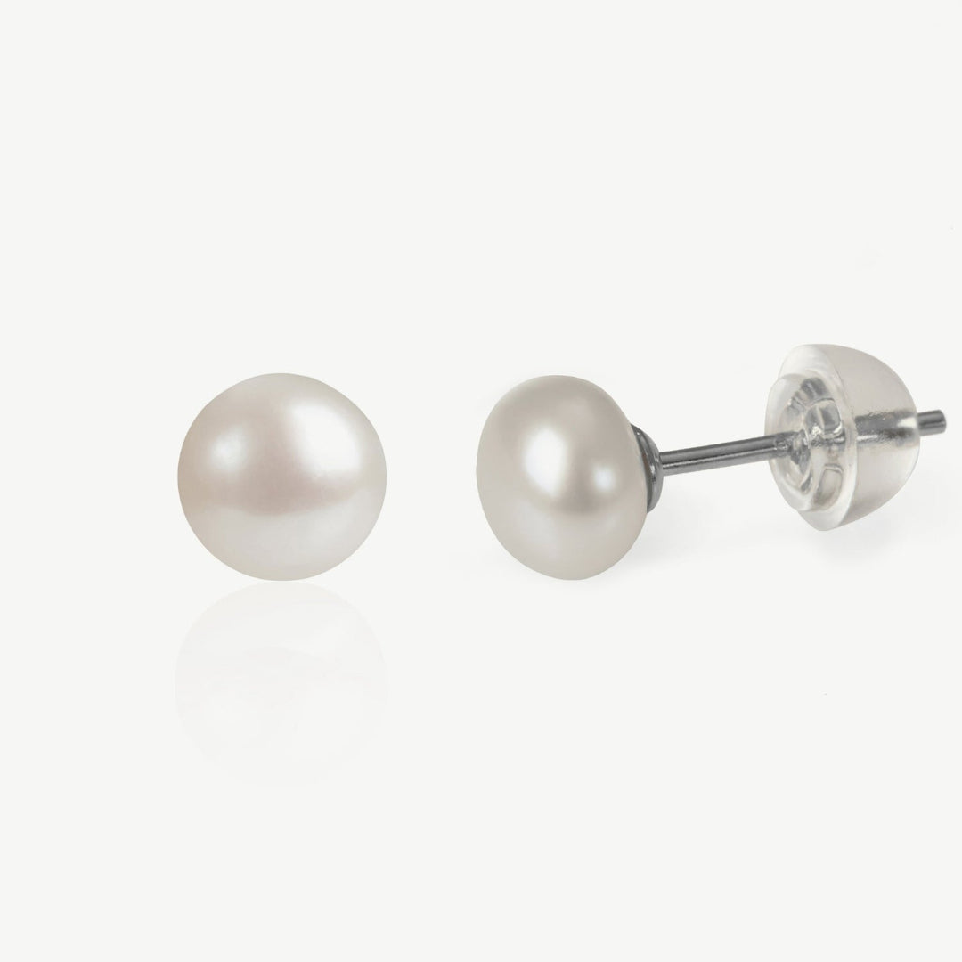 Pair of pearl stud earrings on a white background