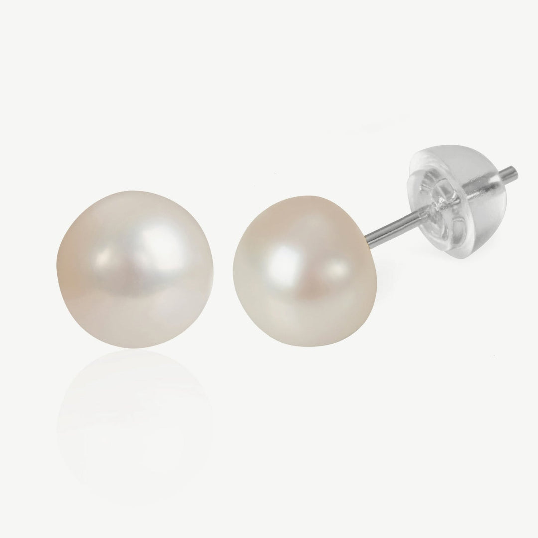Pair of pearl stud earrings on a white background
