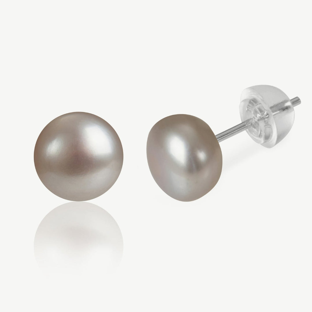 Pair of pearl stud earrings on a white background