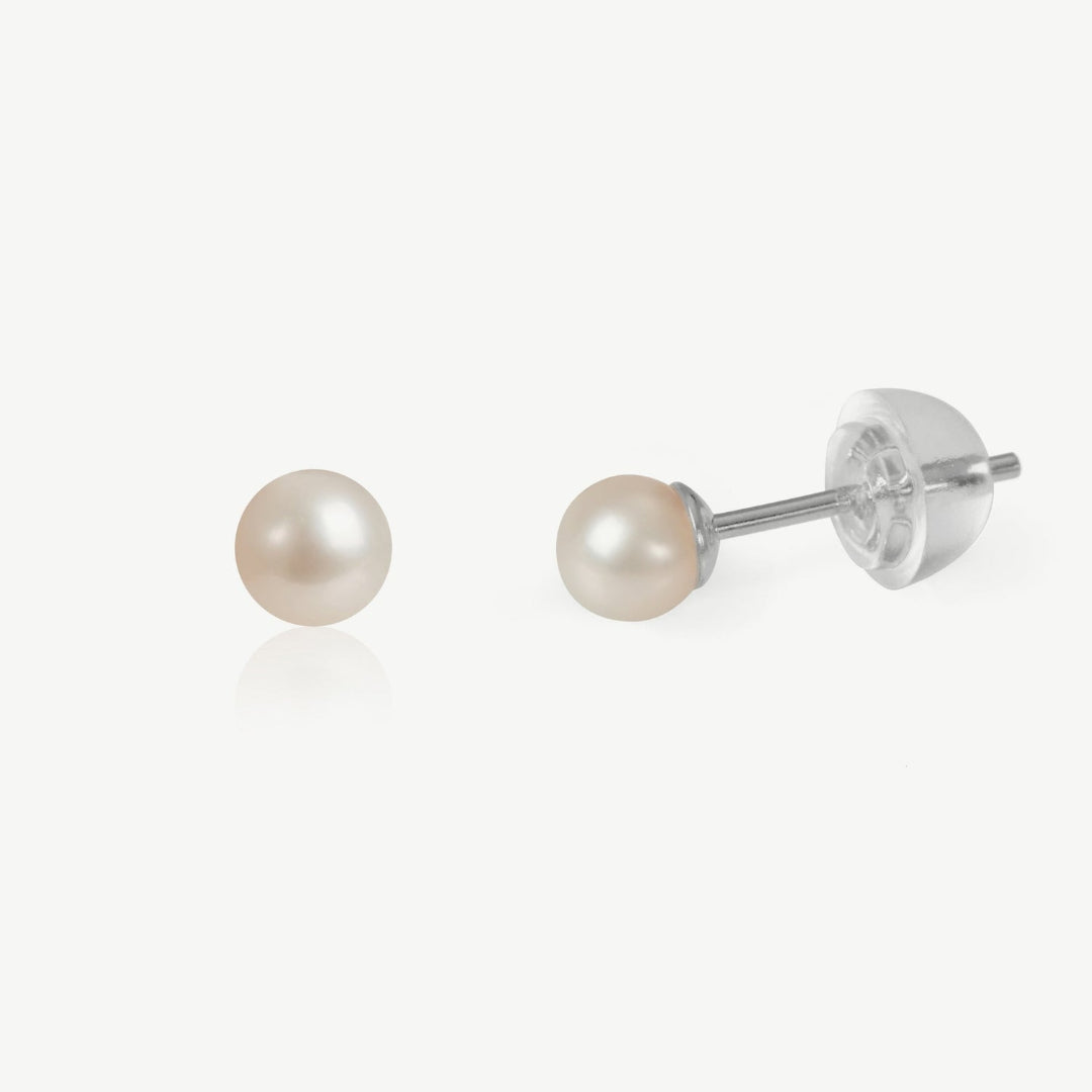 Pair of pearl stud earrings on a white background