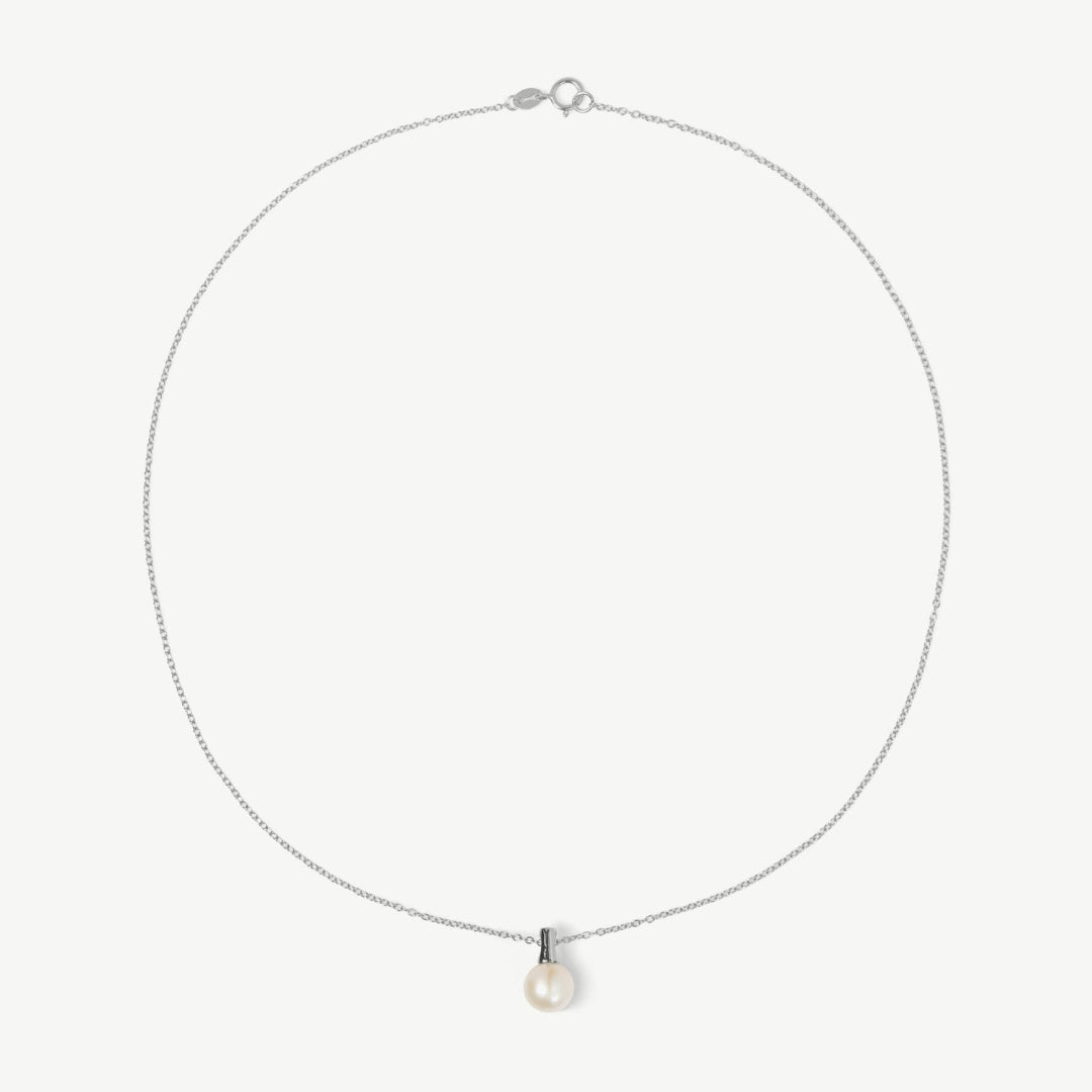 Necklace with a pearl pendant on a light gray background