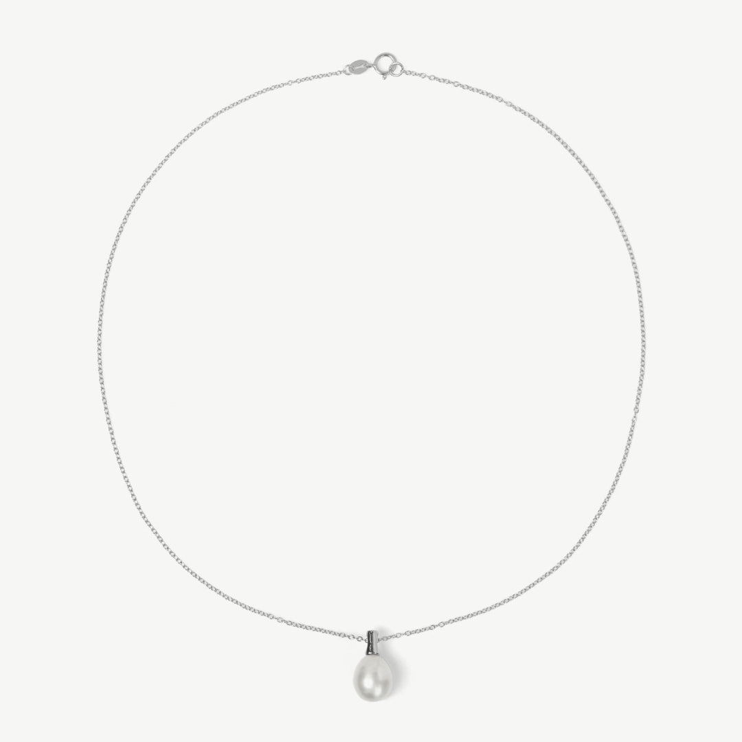 Silver necklace with a teardrop-shaped pendant on a light gray background