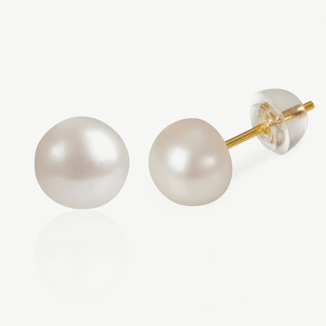 Pearl stud earrings with gold posts on a white background