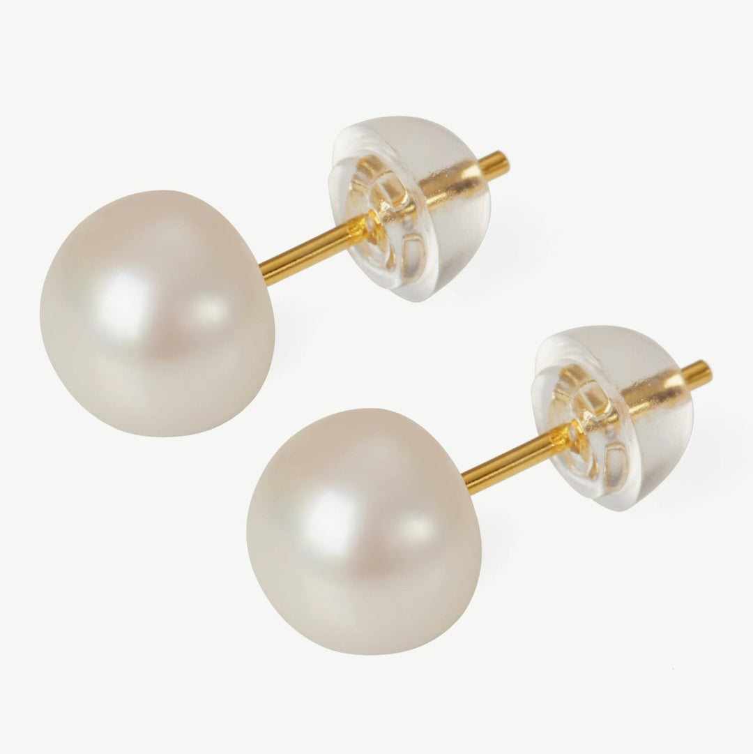 Pearl earrings with gold posts on a white background