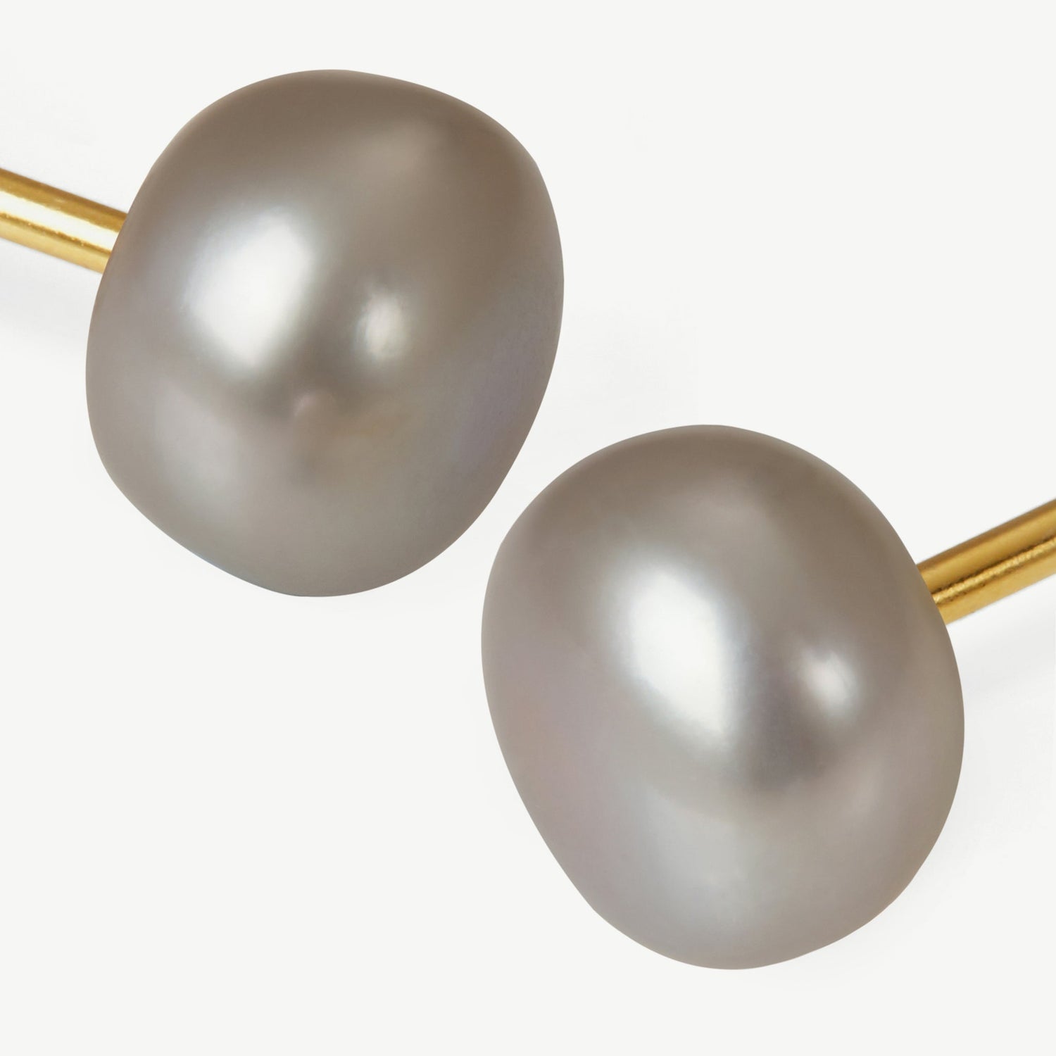 Pearl earrings with gold clasps on a white background