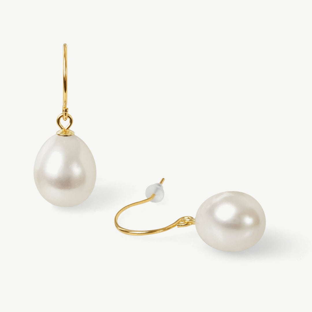 Pearl earrings with gold hooks on a white background