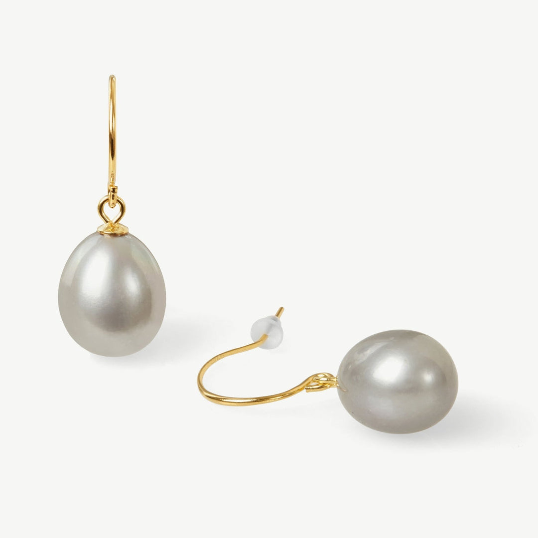 Pearl earrings with gold hooks on a white background
