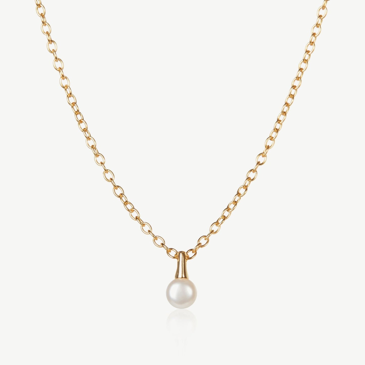 Gold necklace with a pearl pendant on a white background
