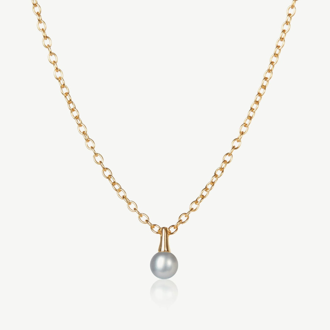 Gold necklace with a single pearl pendant on a white background