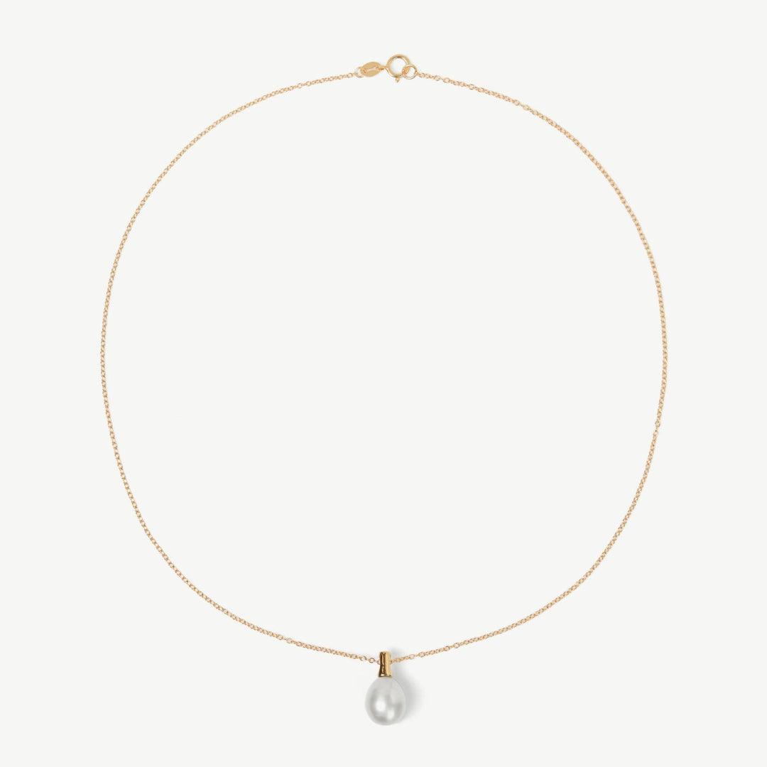 Gold necklace with a pearl pendant on a white background