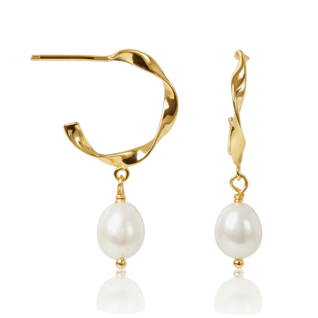 Gold earrings with pearl drops on a white background