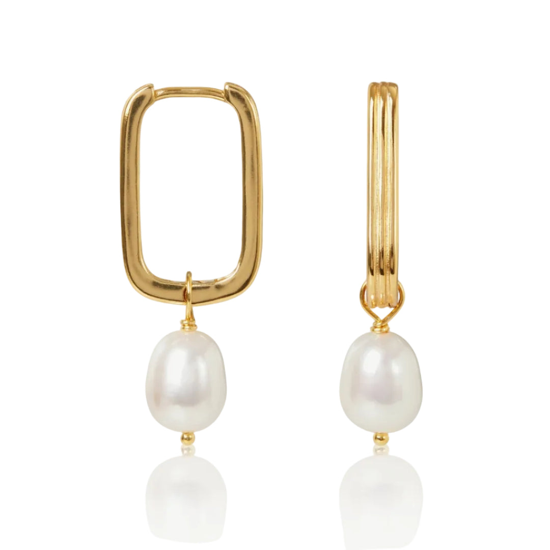 Gold hoop earrings with pearl drops on a white background