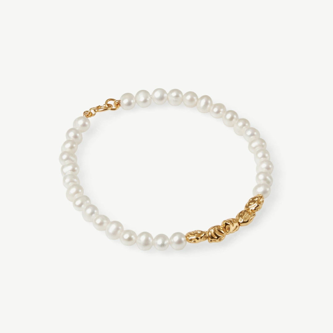 Pearl bracelet with gold clasp on a white background