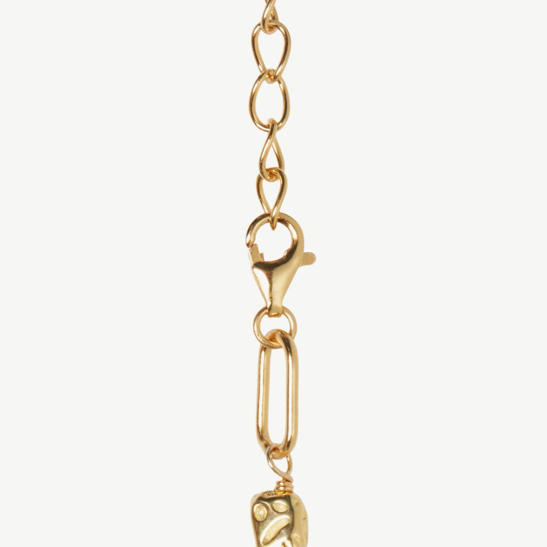 Gold chain bracelet with clasp on a white background