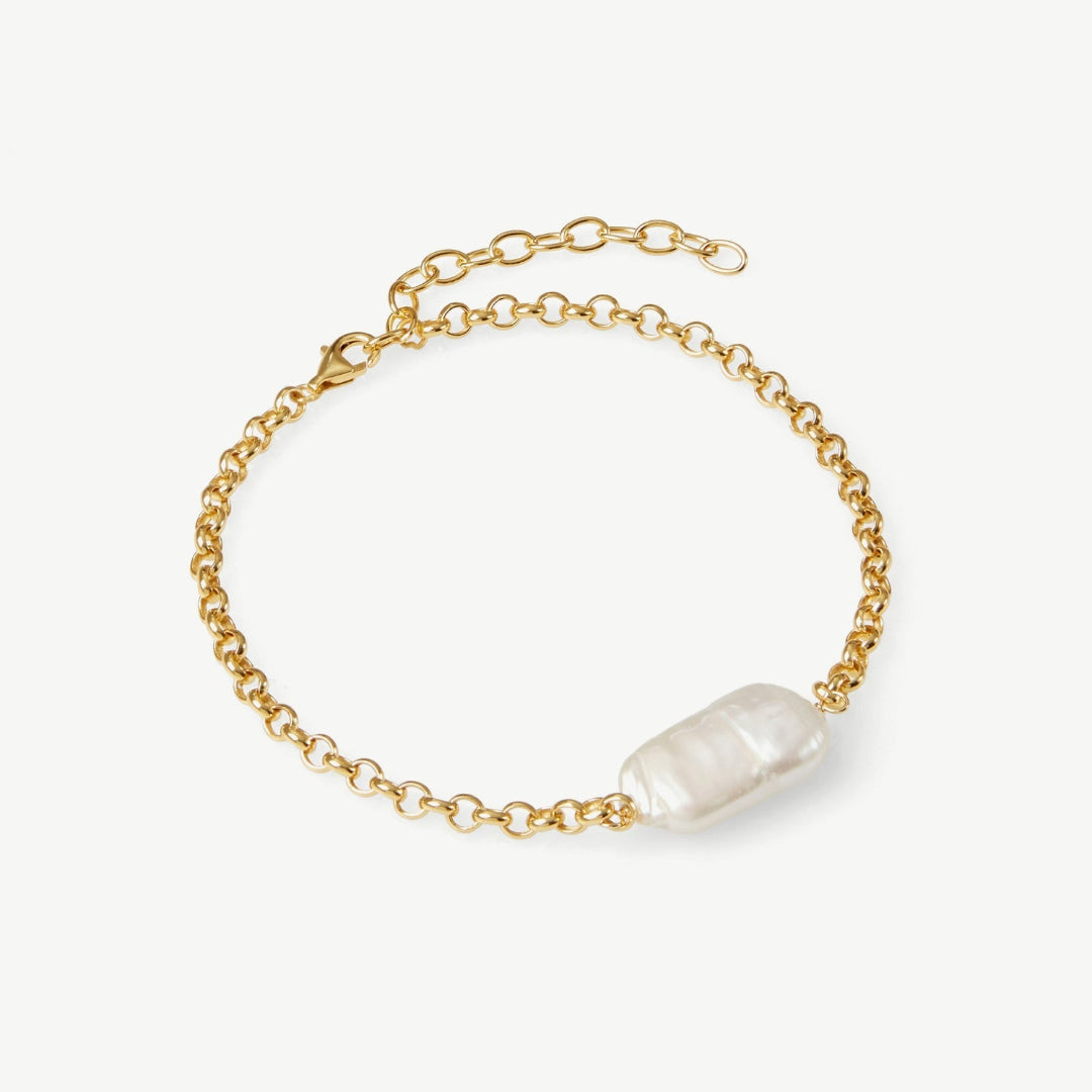 Gold chain bracelet with a pearl on a white background