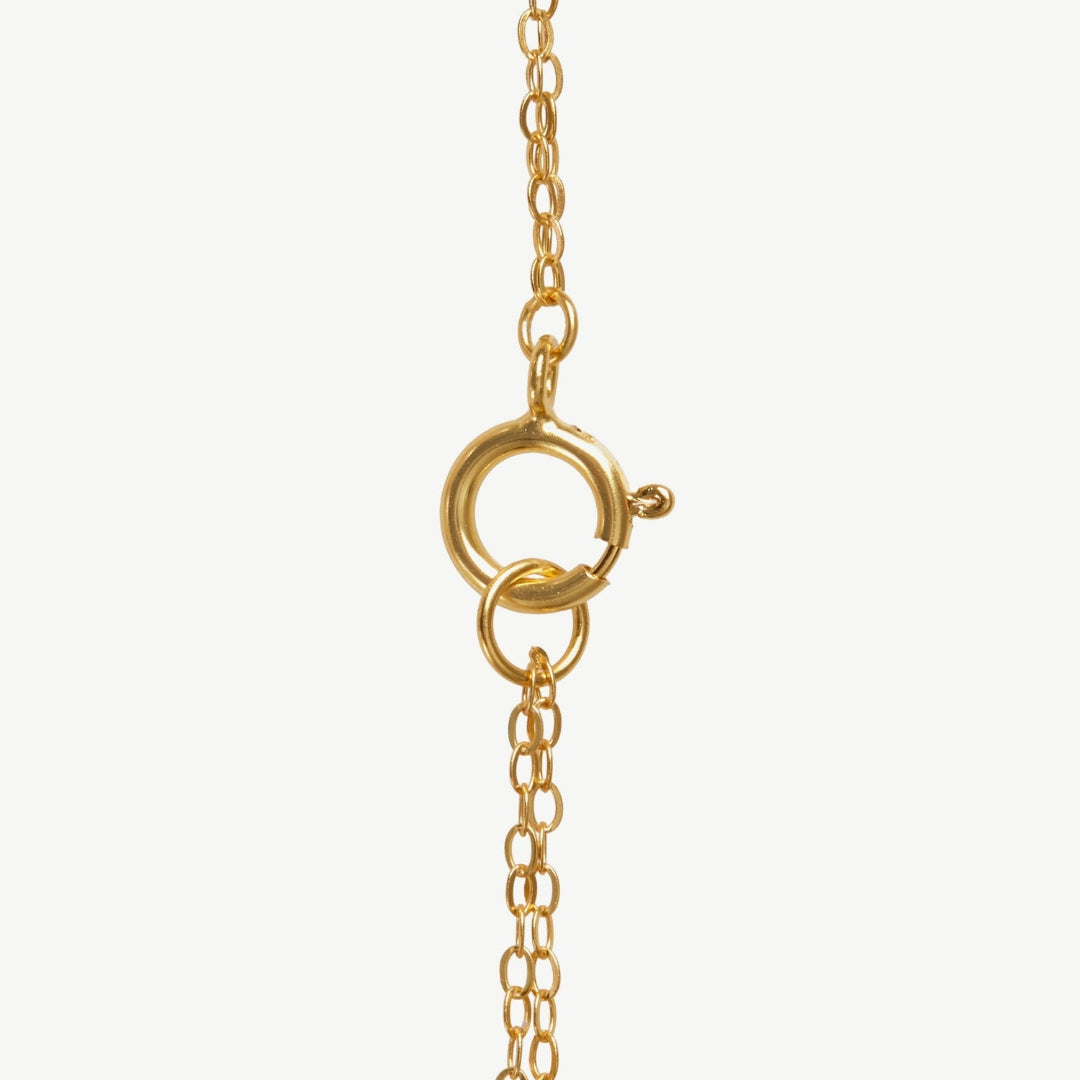 Gold necklace clasp on a white background