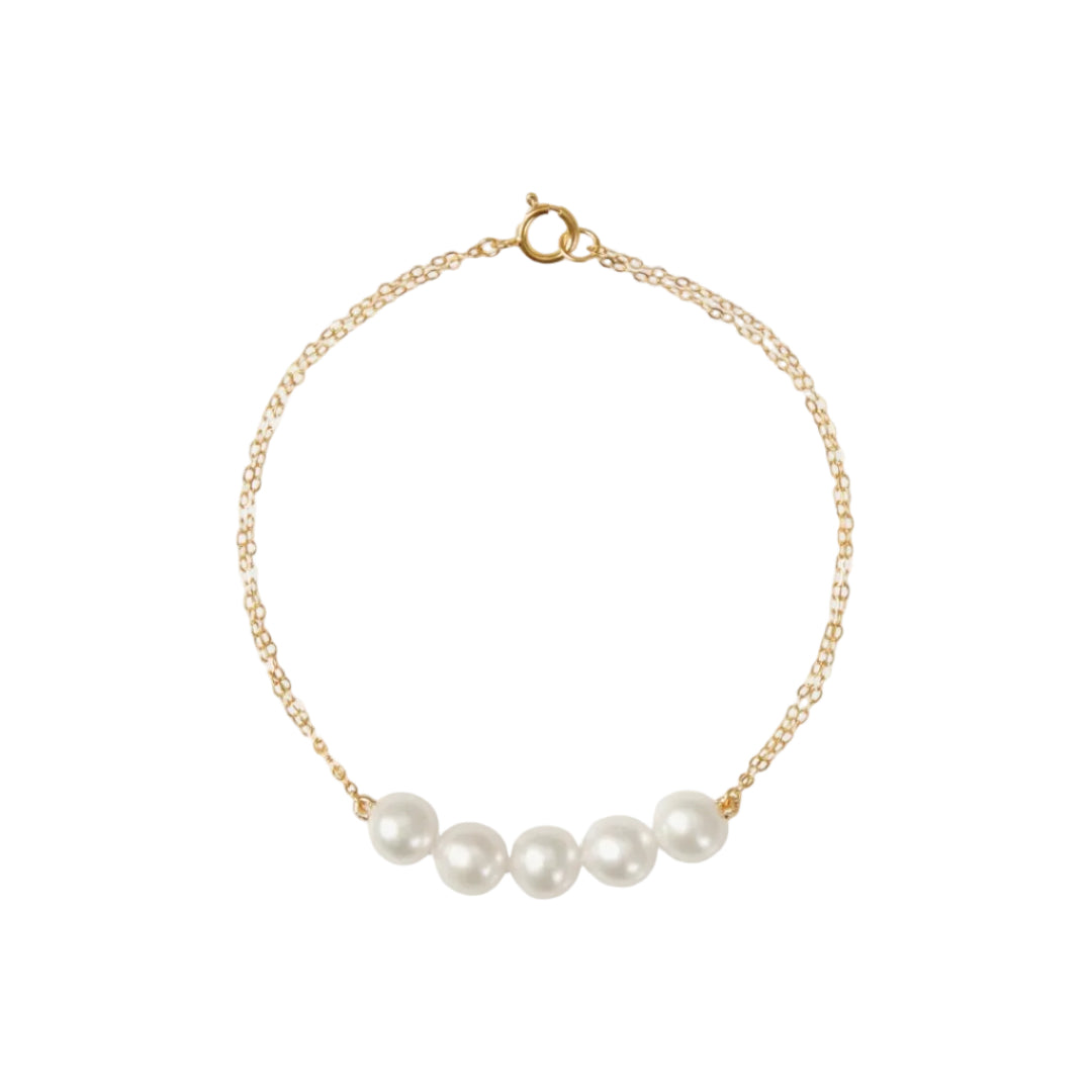 Gold bracelet with pearls on a white background
