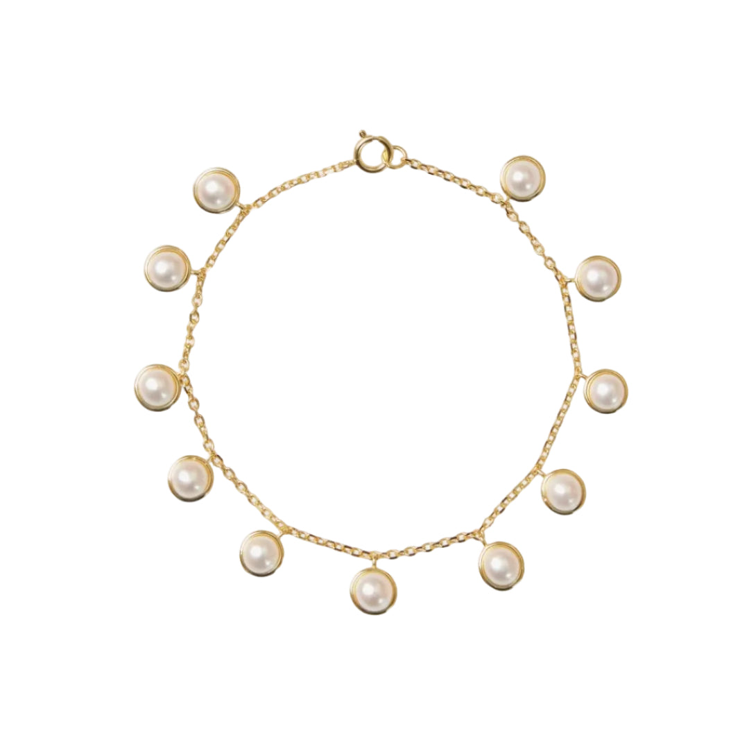 Gold bracelet with pearls on a white background