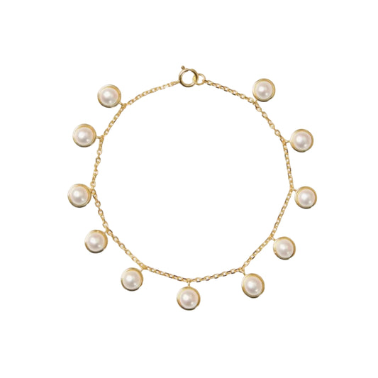 Gold bracelet with pearls on a white background
