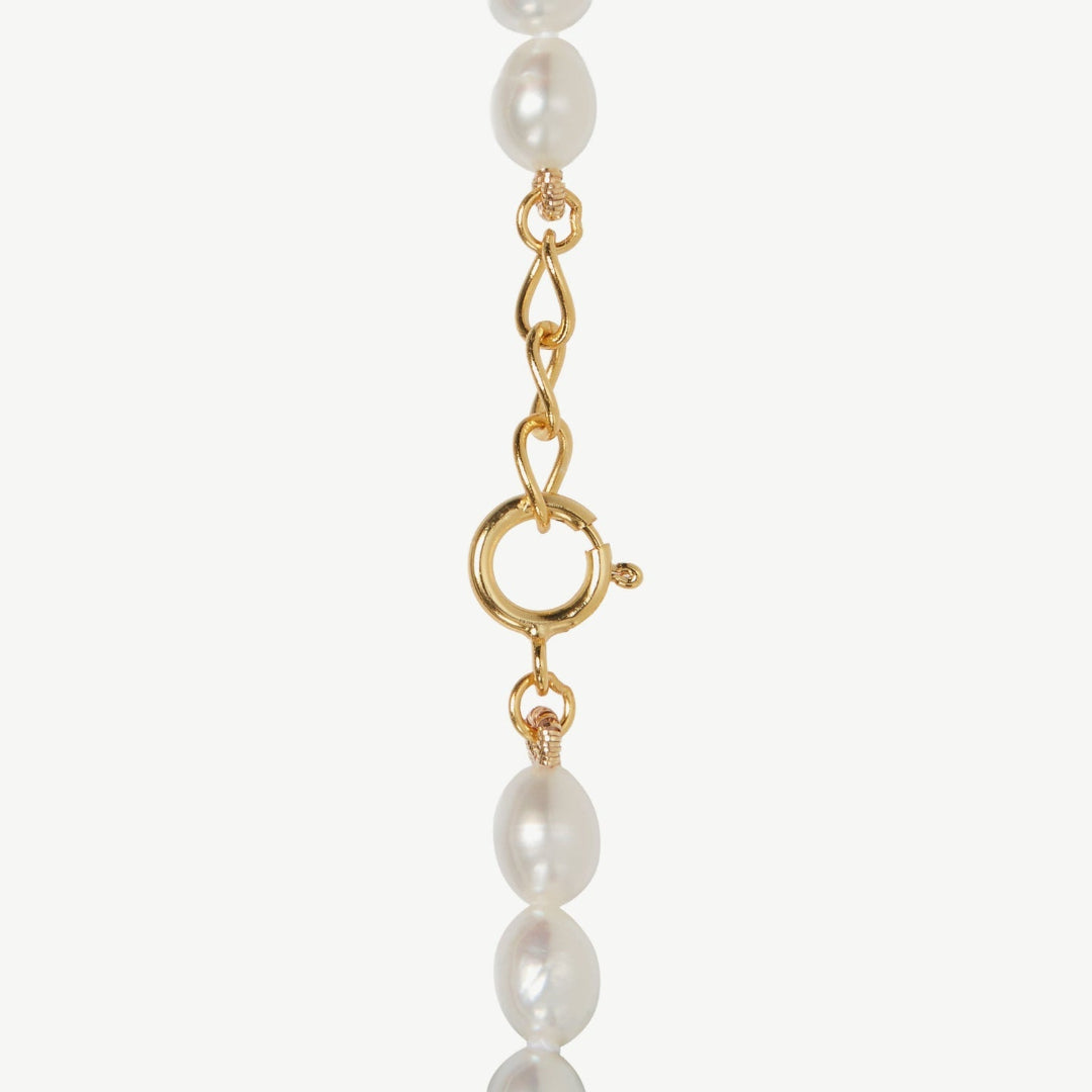 Pearl necklace with gold clasp on a white background