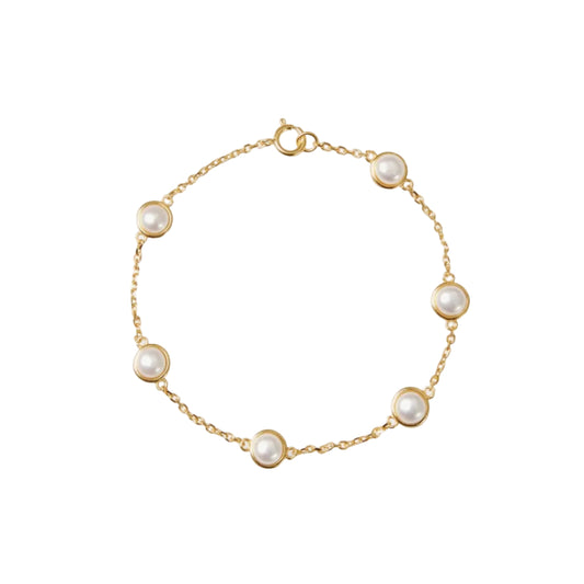 Gold bracelet with pearl beads on a white background
