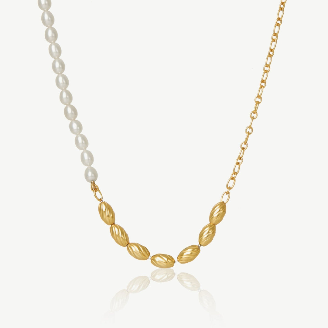 Necklace with gold and pearl beads on a white background