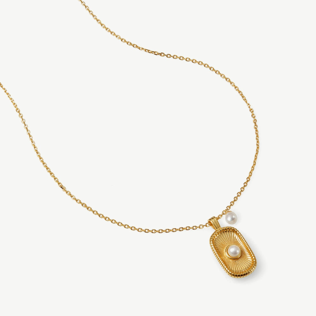 Gold necklace with a pendant on a white background