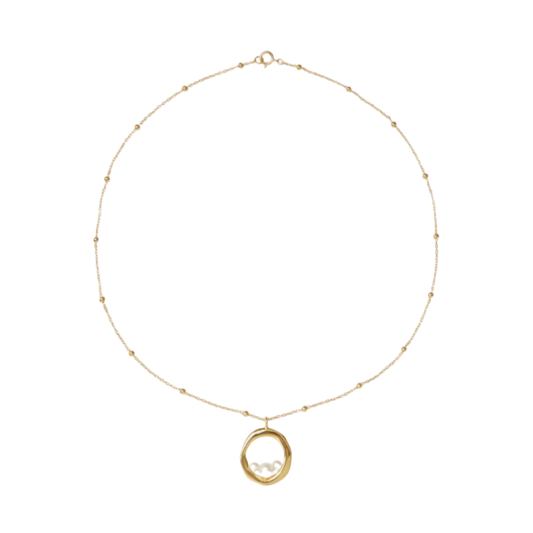 Gold necklace with a pendant on a white background