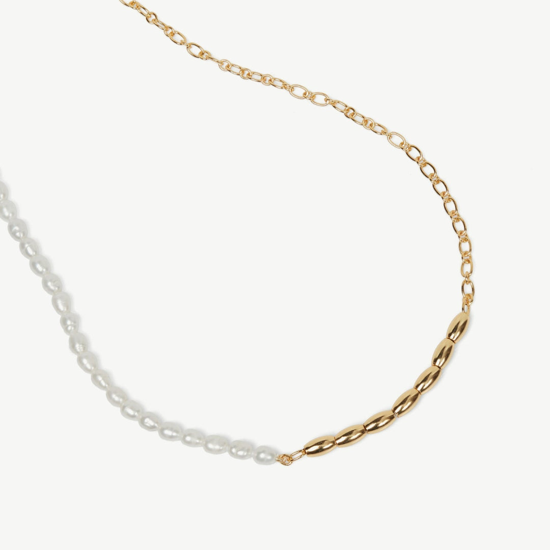 Gold and silver chain necklace on a white background