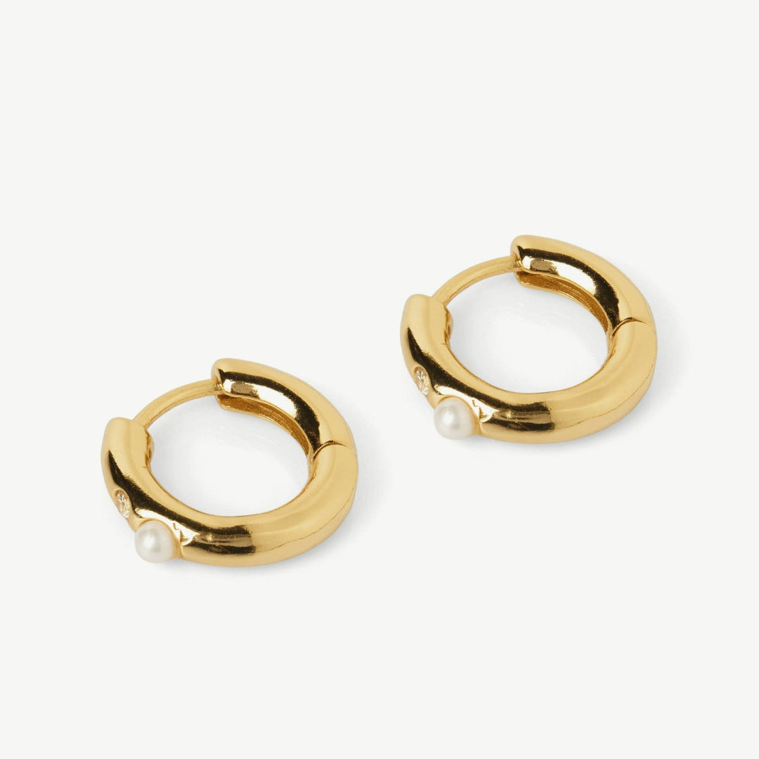 Gold hoop earrings with pearl accents on a white background