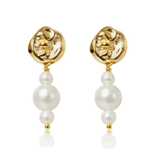 Gold earrings with pearl drops on a white background
