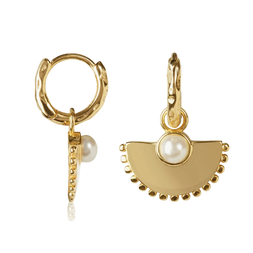Gold hoop earrings with half-circle pendants and pearls on a white background