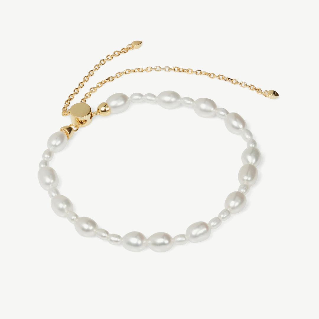 Pearl bracelet with gold clasp on a white background
