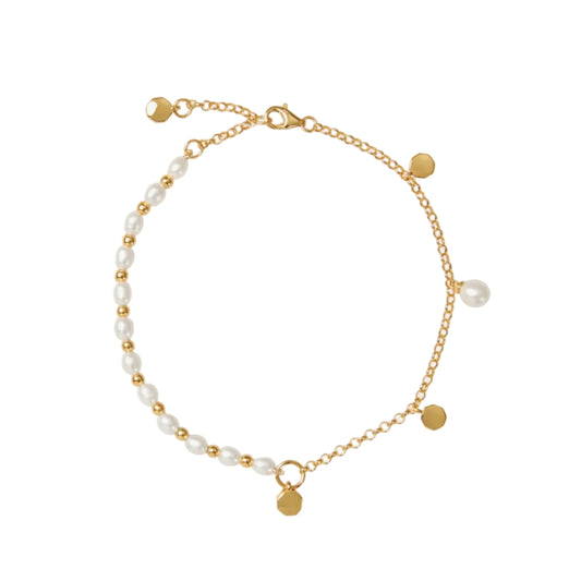 Gold bracelet with pearls on a white background