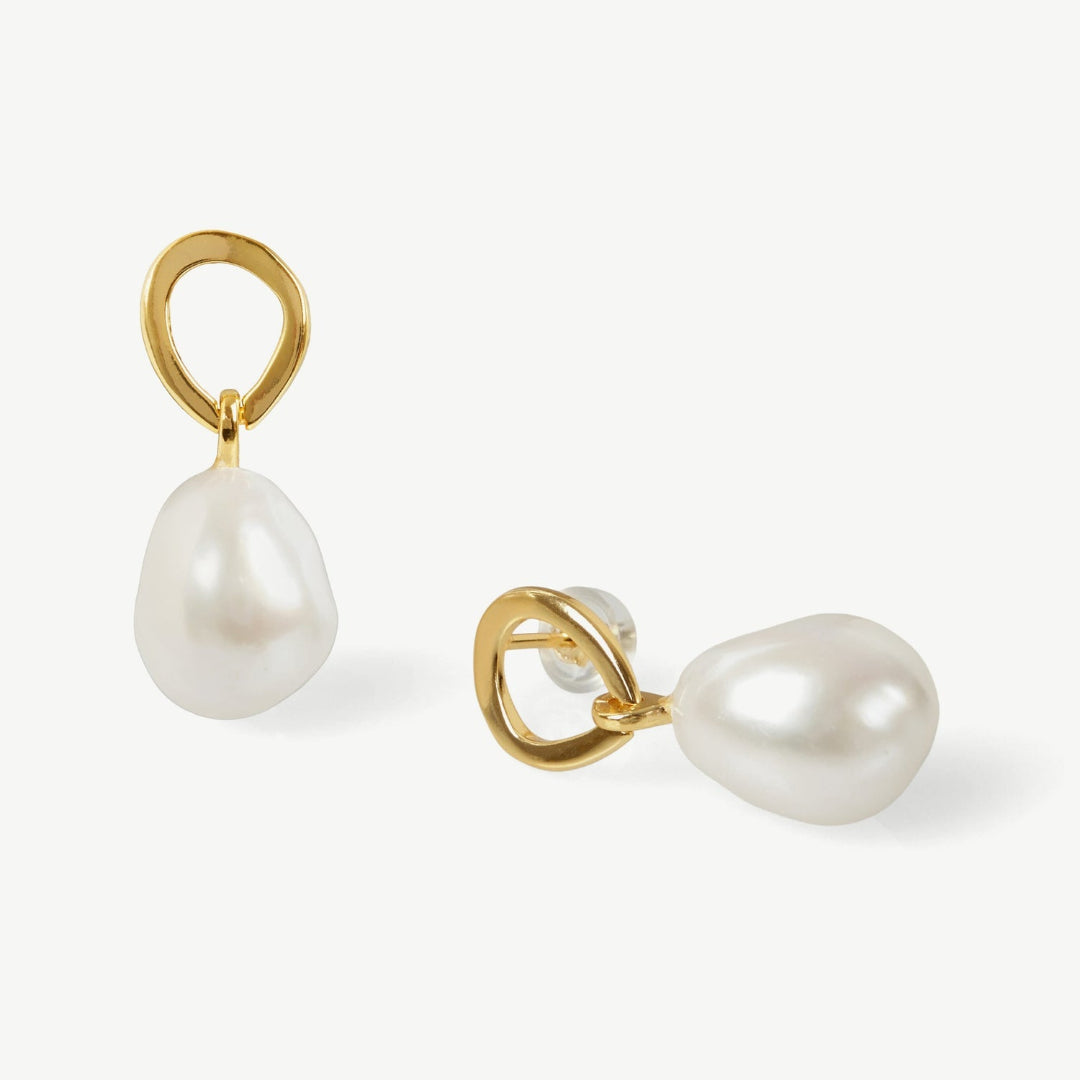 Pearl earrings with gold hooks on a white background