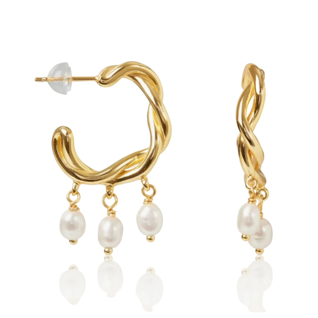 Gold hoop earrings with pearl drops on a white background