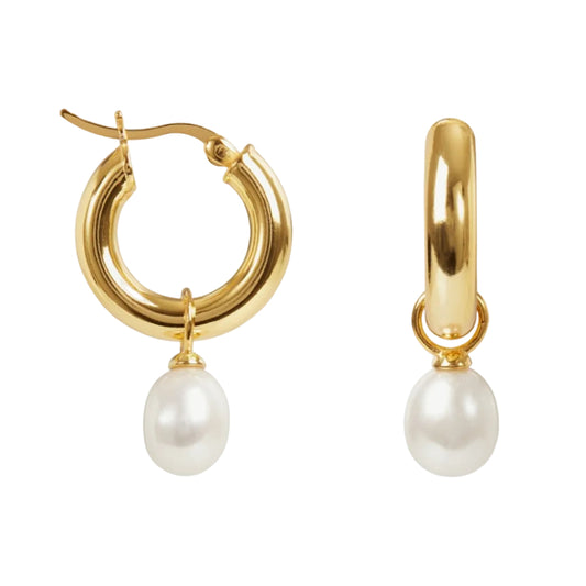 Gold hoop earrings with pearl drops on a white background