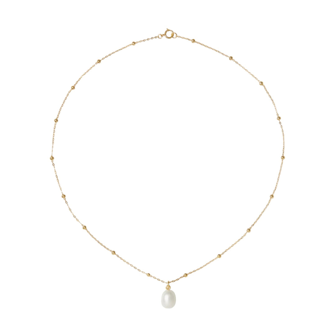 Gold necklace with a single pearl pendant on a white background