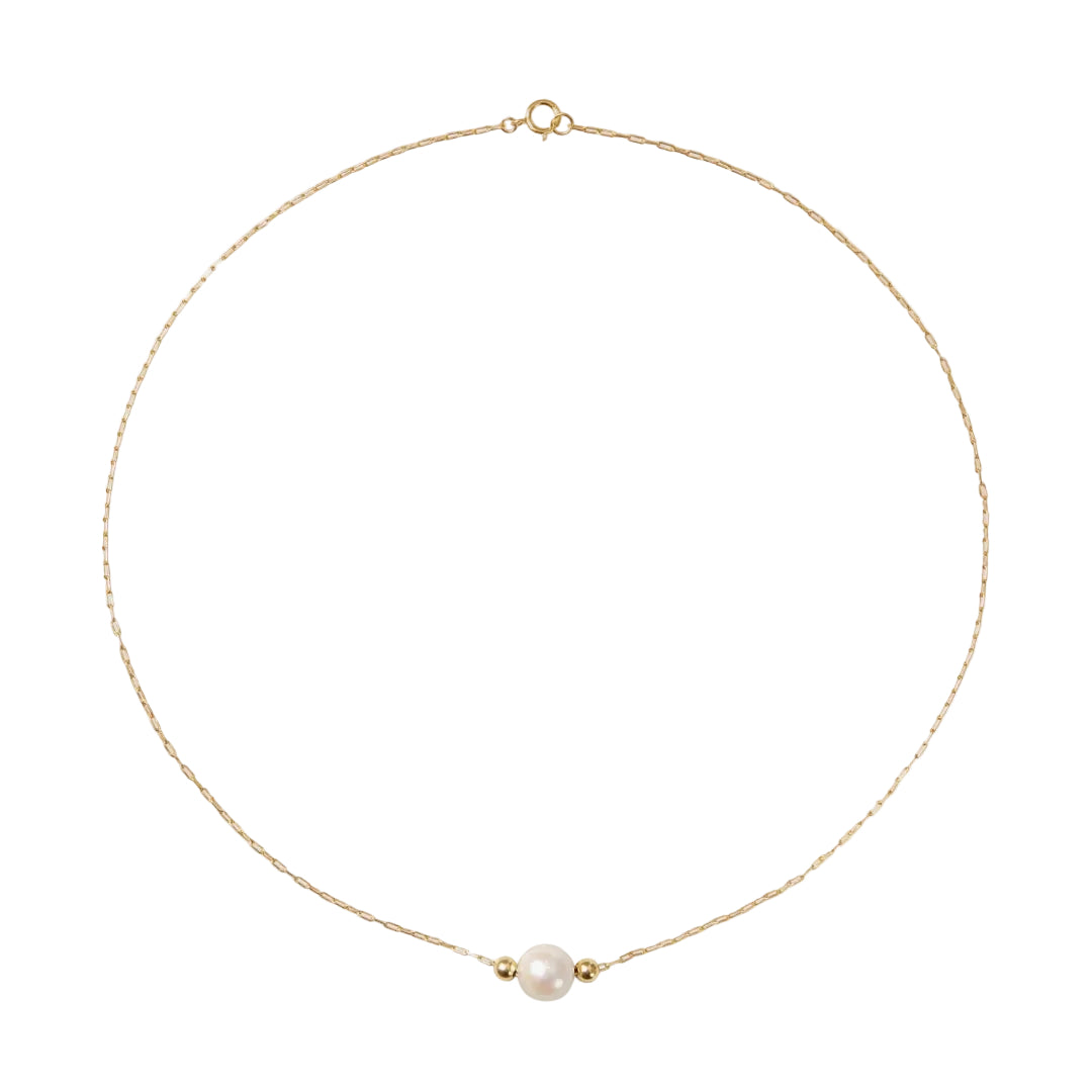 Gold necklace with a single pearl on a white background