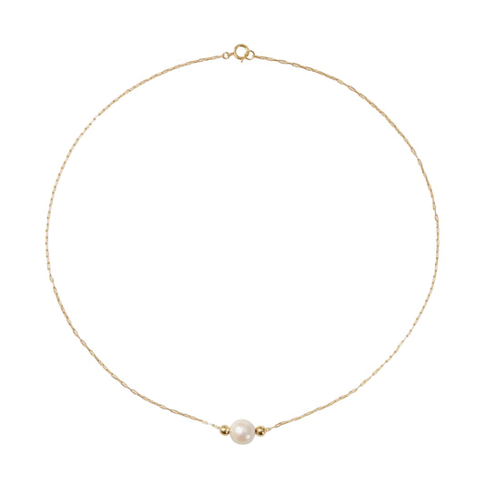 Gold necklace with a single pearl on a white background