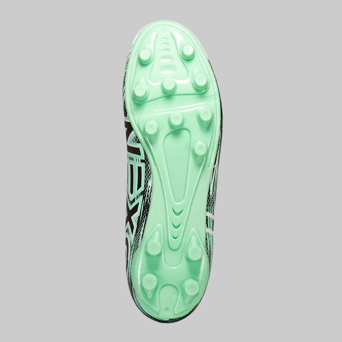 Close-up of a green soccer cleat sole with brand logo on a white background